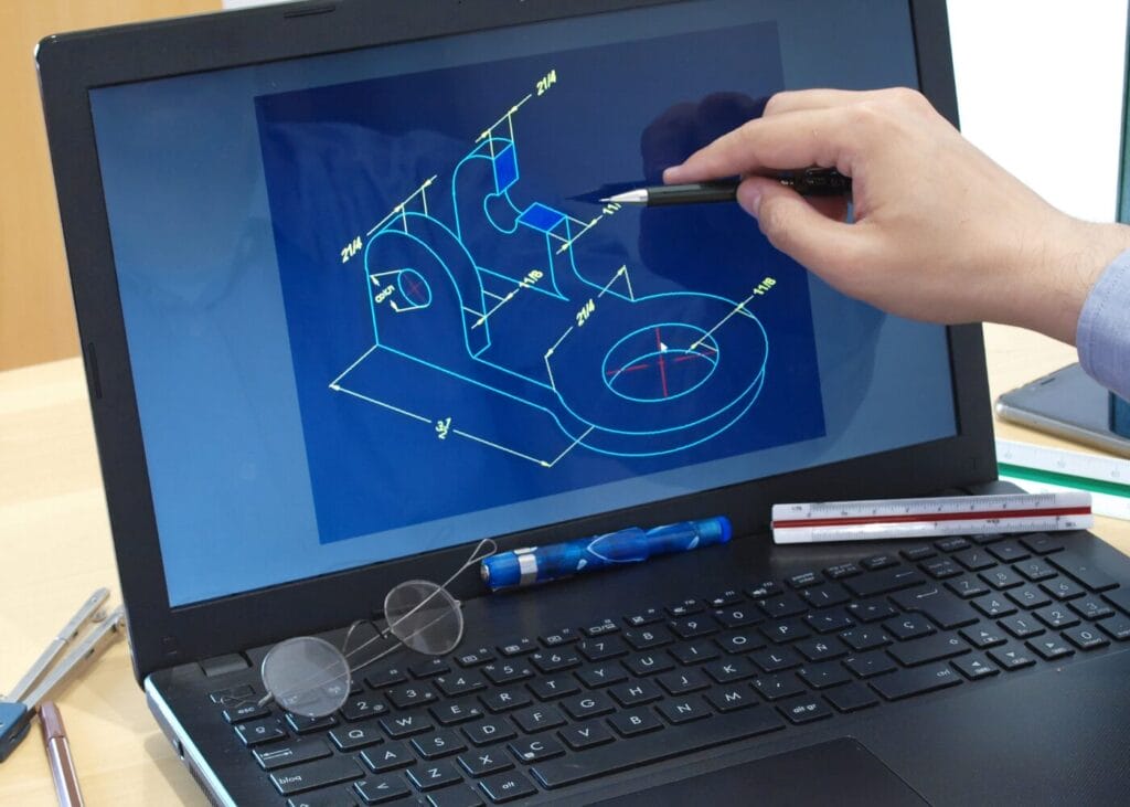 Engineer reviewing 3D CAD design on laptop